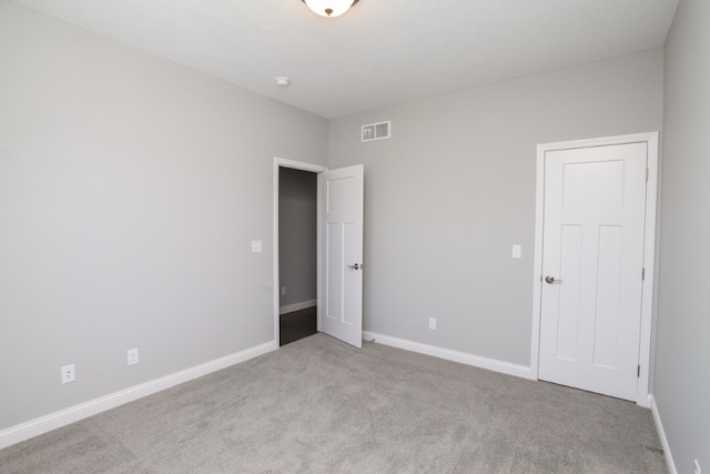 unfurnished bedroom with light colored carpet