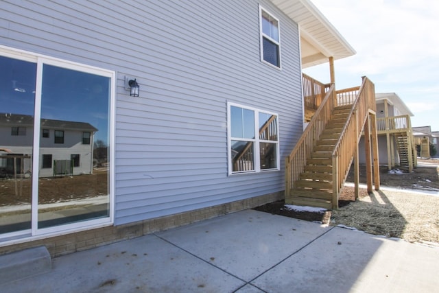 rear view of house featuring a patio and a wooden deck