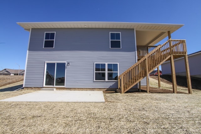 rear view of property featuring a patio and a wooden deck