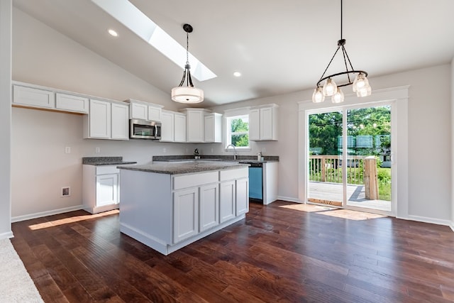 kitchen with recessed lighting, white cabinets, stainless steel microwave, and dark wood finished floors