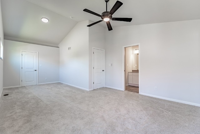 unfurnished bedroom with light carpet, ceiling fan, ensuite bath, and baseboards