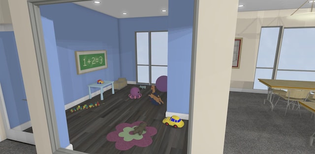 rec room featuring dark colored carpet