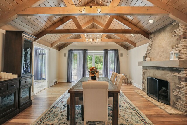 dining area featuring wooden ceiling, vaulted ceiling with beams, light wood-type flooring, and an inviting chandelier