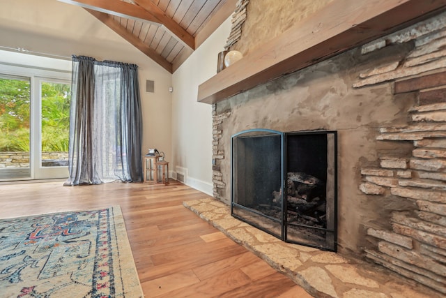 unfurnished living room with wood ceiling, light hardwood / wood-style floors, high vaulted ceiling, beam ceiling, and a stone fireplace