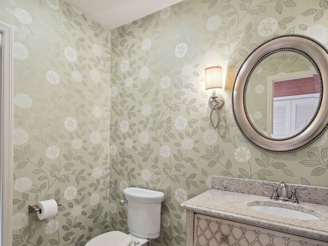 bathroom featuring toilet and vanity