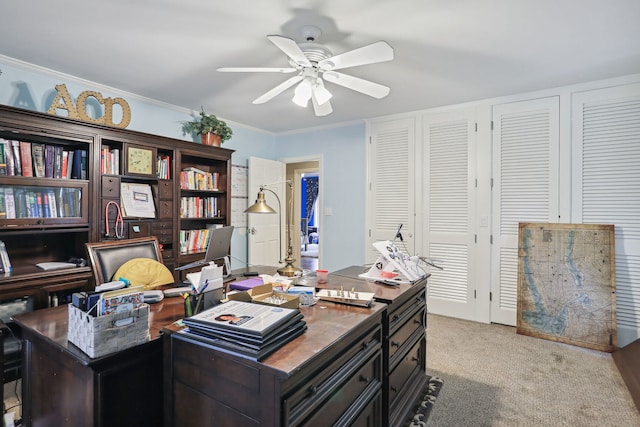 office area featuring light carpet, crown molding, and ceiling fan