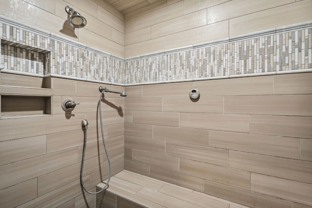 bathroom with a tile shower