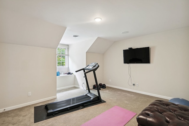 workout area with vaulted ceiling and light colored carpet