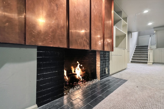 details with hardwood / wood-style floors and a brick fireplace