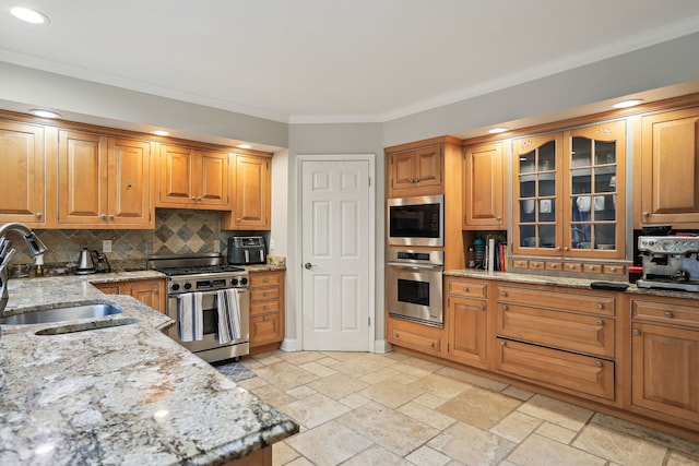 kitchen featuring appliances with stainless steel finishes, sink, light tile floors, light stone counters, and tasteful backsplash