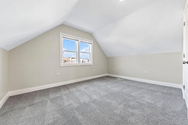 bonus room with carpet floors and vaulted ceiling