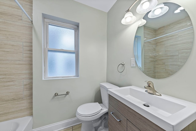 full bathroom with tiled shower / bath, toilet, tile floors, and vanity