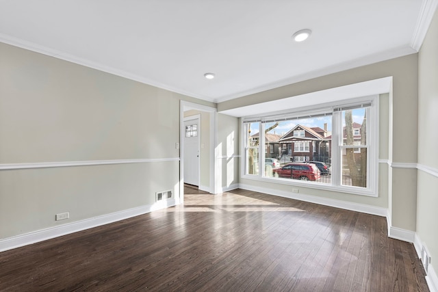 empty room featuring plenty of natural light, dark hardwood / wood-style flooring, and ornamental molding