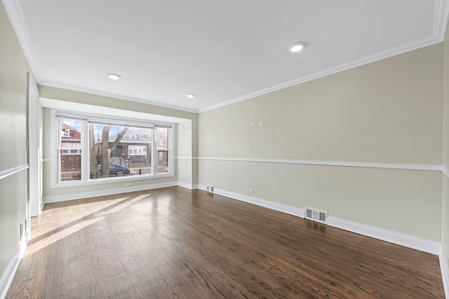 spare room featuring dark hardwood / wood-style flooring and ornamental molding