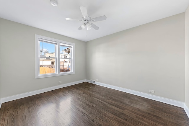 empty room with ceiling fan and dark wood-type flooring