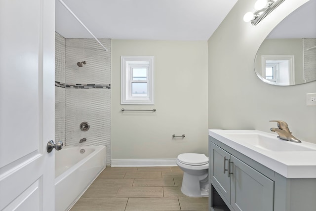 full bathroom featuring large vanity, toilet, tiled shower / bath combo, and tile floors