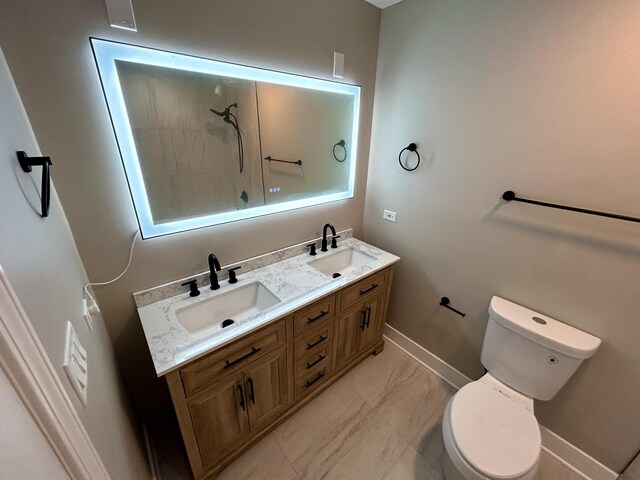 full bathroom featuring a sink, toilet, a shower, and baseboards