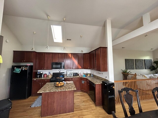 kitchen featuring light wood-style floors, high vaulted ceiling, stone counters, black appliances, and open floor plan
