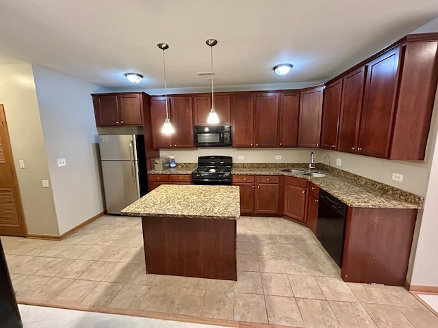 kitchen featuring stone countertops, light tile patterned floors, a kitchen island, black appliances, and a sink