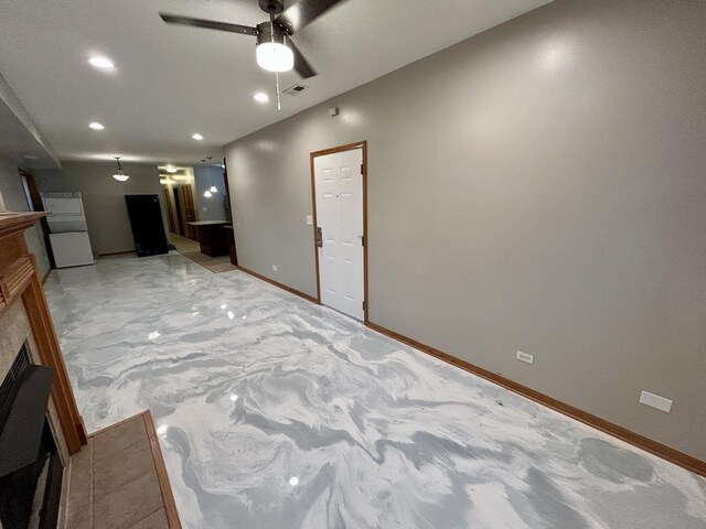 interior space with baseboards, recessed lighting, a fireplace, a ceiling fan, and visible vents