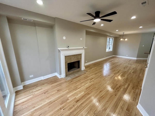 unfurnished living room featuring light wood finished floors, visible vents, and ceiling fan