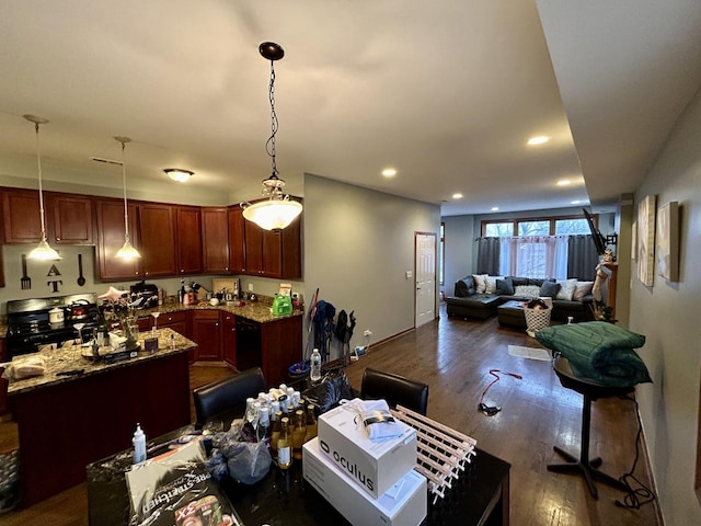kitchen with open floor plan, dark wood-type flooring, gas stove, and light stone countertops