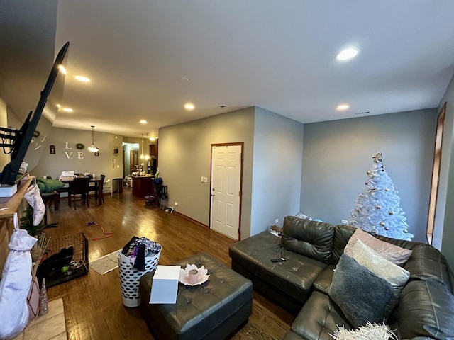 living area featuring wood finished floors and recessed lighting