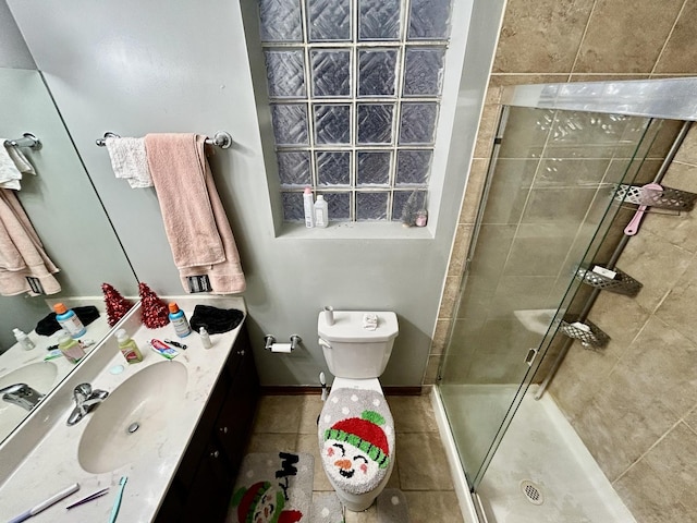 bathroom with toilet, a shower stall, and vanity