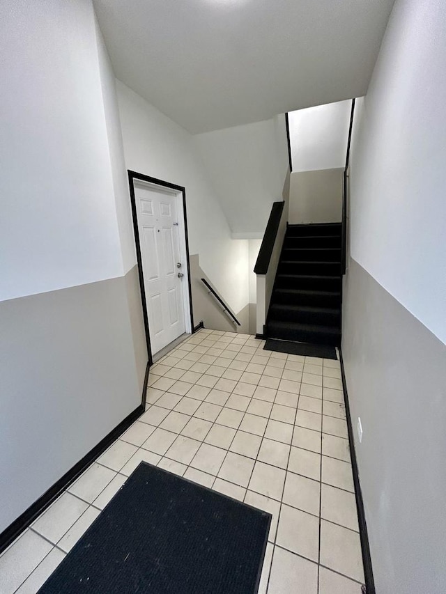 staircase featuring tile patterned floors