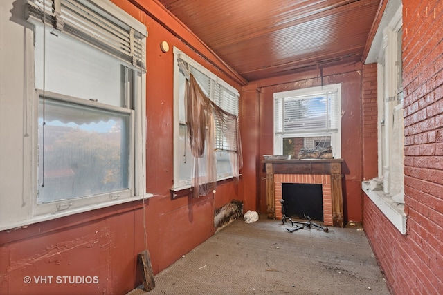 interior space featuring wooden ceiling and a fireplace