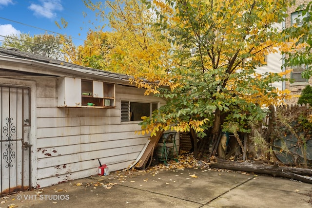 view of side of property with a patio