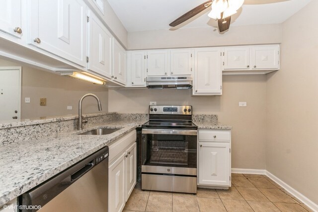 kitchen featuring ceiling fan, stainless steel appliances, light tile floors, sink, and white cabinetry