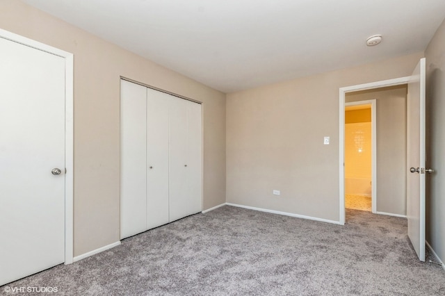 unfurnished bedroom with a closet and light carpet