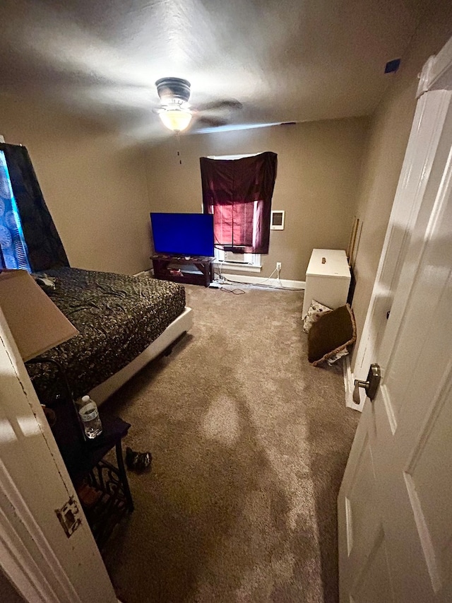 bedroom featuring dark carpet and ceiling fan