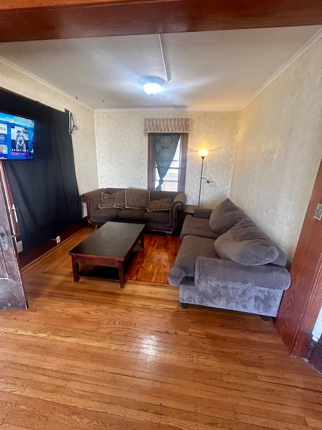 living room with ornamental molding and hardwood / wood-style floors