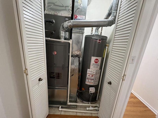 utility room featuring gas water heater