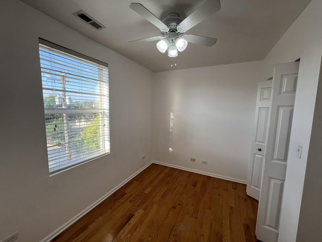 unfurnished room featuring ceiling fan and dark hardwood / wood-style flooring