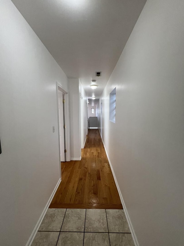 hall featuring light tile patterned flooring