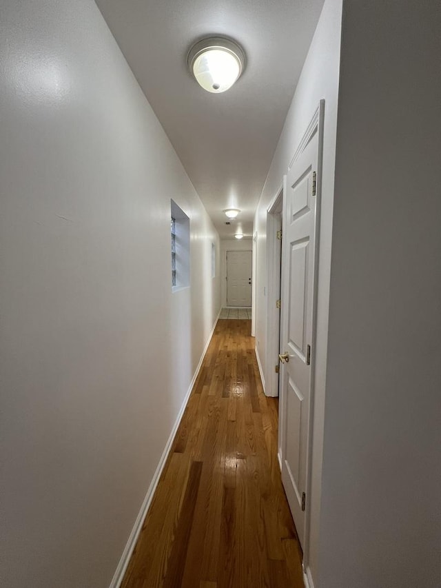 hallway with wood-type flooring