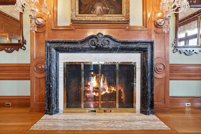 details featuring a premium fireplace and hardwood / wood-style floors