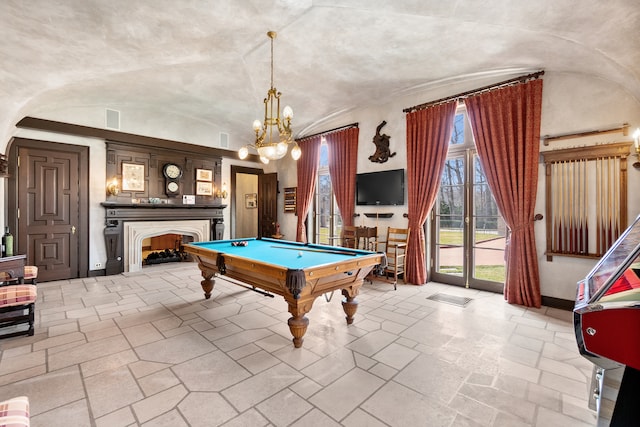 rec room with an inviting chandelier, light tile floors, vaulted ceiling, and billiards