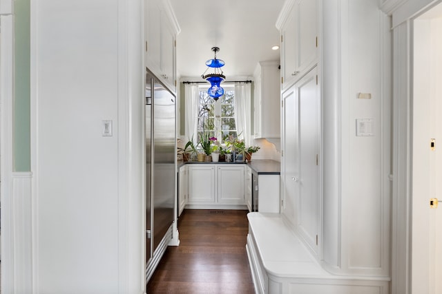 hall with dark wood-type flooring and beverage cooler