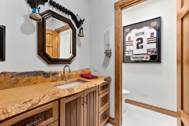 bathroom featuring vanity, tile floors, and toilet