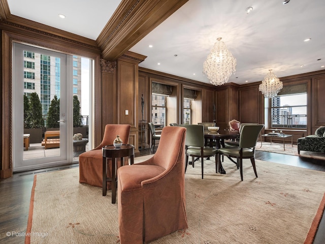 interior space featuring ornamental molding, a chandelier, wood-type flooring, and wooden walls