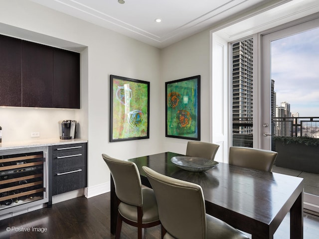 dining space featuring beverage cooler and dark hardwood / wood-style flooring