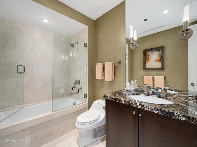 full bathroom featuring bath / shower combo with glass door, ornamental molding, toilet, and vanity