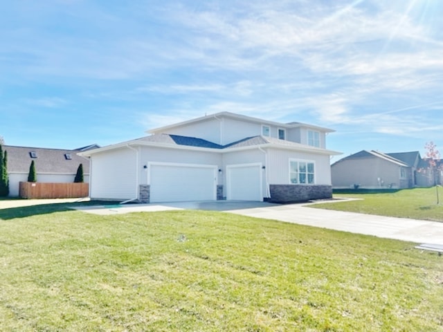 view of front of home with a front yard and a garage