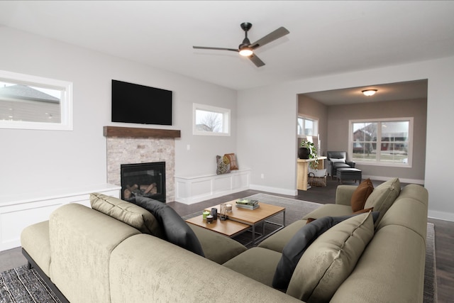 living room with ceiling fan, dark wood-type flooring, and a healthy amount of sunlight