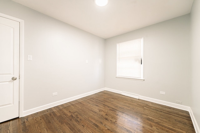 spare room with dark wood-type flooring