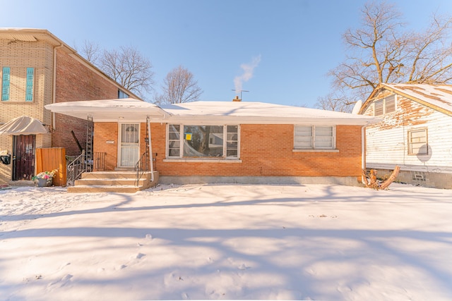 view of snow covered back of property